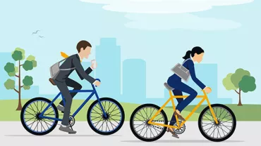 Duas pessoas andando de bicicleta em um parque urbano.