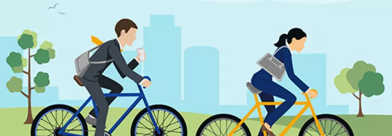 Duas pessoas andando de bicicleta em um parque urbano.