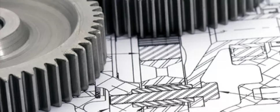 Engrenagens metálicas sobre um desenho técnico detalhado.